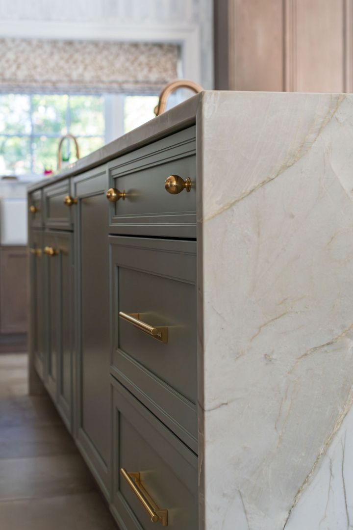 Close-up of green kitchen island with gold hardware in a custom Chatham Boro, NJ home by G&L and Sons Renovations
