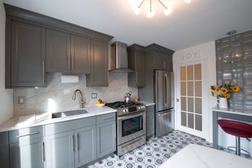 Custom kitchen with marble backsplash, stainless appliances, and modern gray cabinetry in Clifton, NJ, by G&L and Sons Renovations