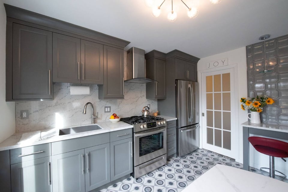Custom kitchen with marble backsplash, stainless appliances, and modern gray cabinetry in Clifton, NJ, by G&L and Sons Renovations