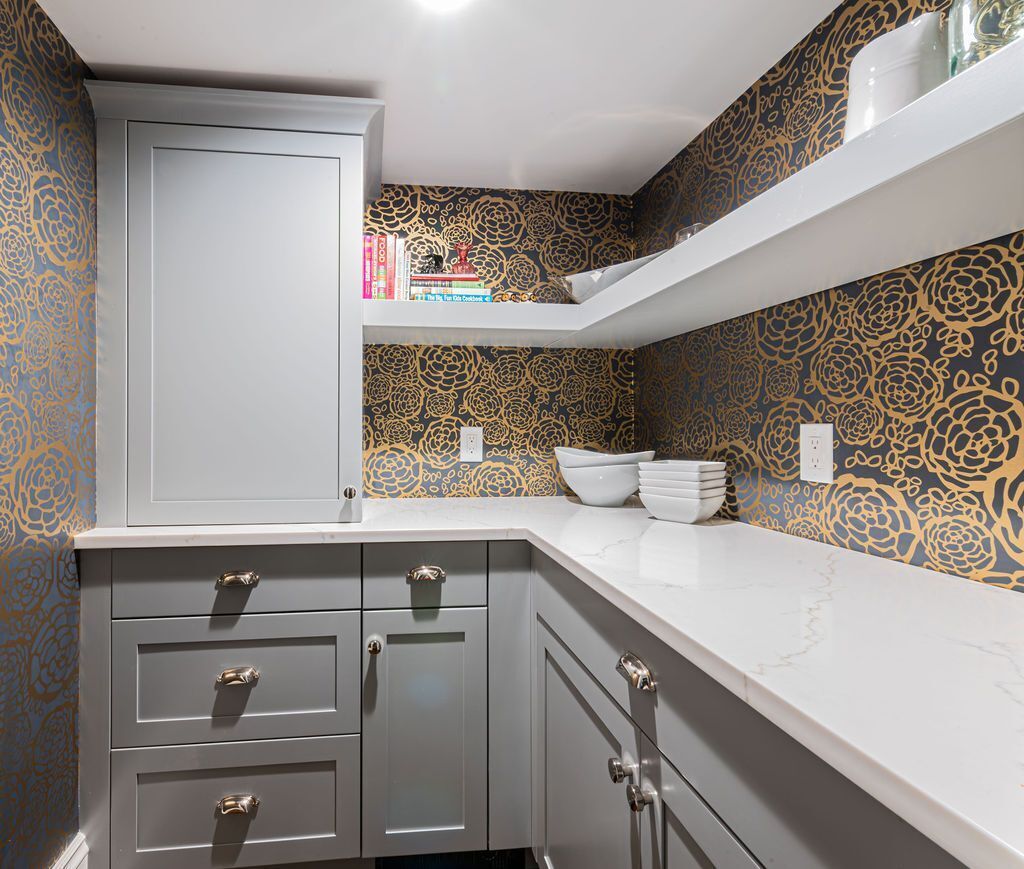 Custom pantry cabinetry and quartz counters with floral wallpaper designed by G&L and Sons Renovations in Livingston, NJ