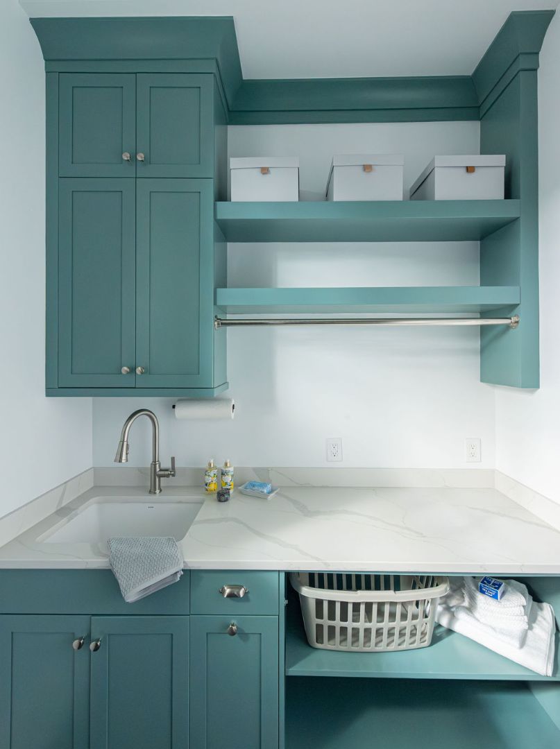 Elegant laundry room renovation with upper storage shelves in a Short Hills, NJ custom home by G&L and Sons Renovations