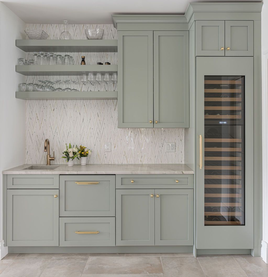 Elegant wet bar with green cabinetry and gold accents by G&L and Sons Renovations in Essex Fells, NJ
