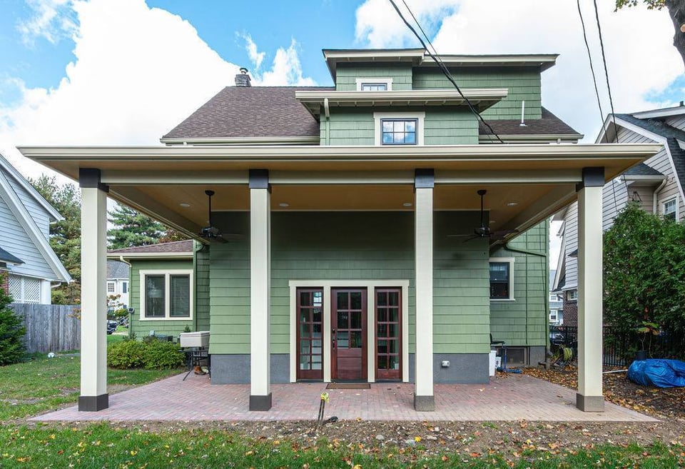 Exterior remodel featuring a green siding home and large patio cover by G&L and Sons Renovations in West Orange, NJ