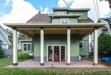 Exterior remodel featuring a green siding home and large patio cover by G&L and Sons Renovations in West Orange, NJ
