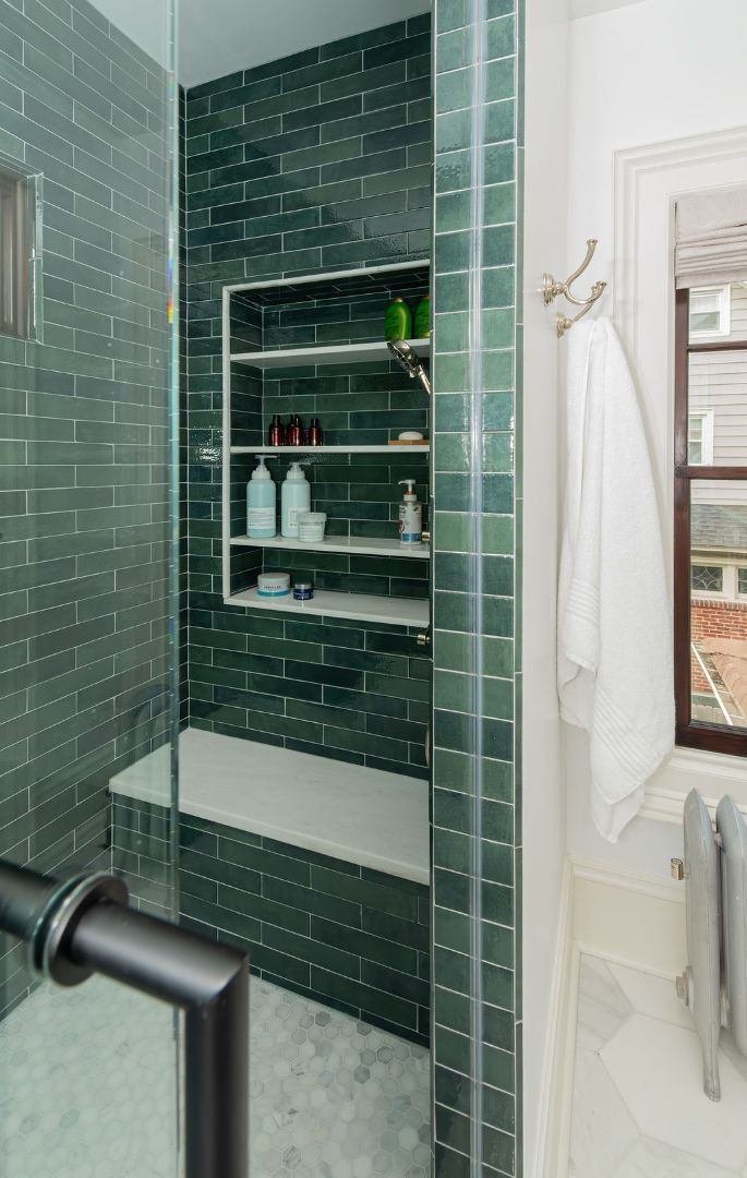 Green tile walk-in shower with bench and niche storage in Caldwell, NJ custom bathroom by G&L and Sons Renovations