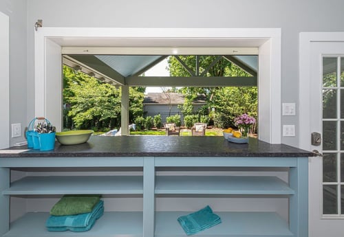 Indoor pass-through bar with backyard view and custom shelving by G&L and Sons Renovations in South Orange, NJ