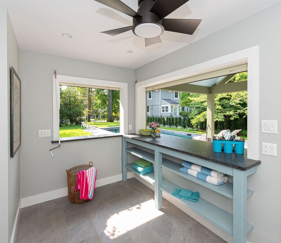 Poolside bar area with open pass-through window and towel storage in Little Falls, NJ by G&L and Sons Renovations