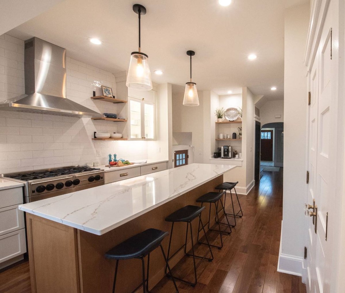 Side view of modern kitchen remodel with custom range hood and island in a Livingston, NJ home by G&L and Sons Renovations