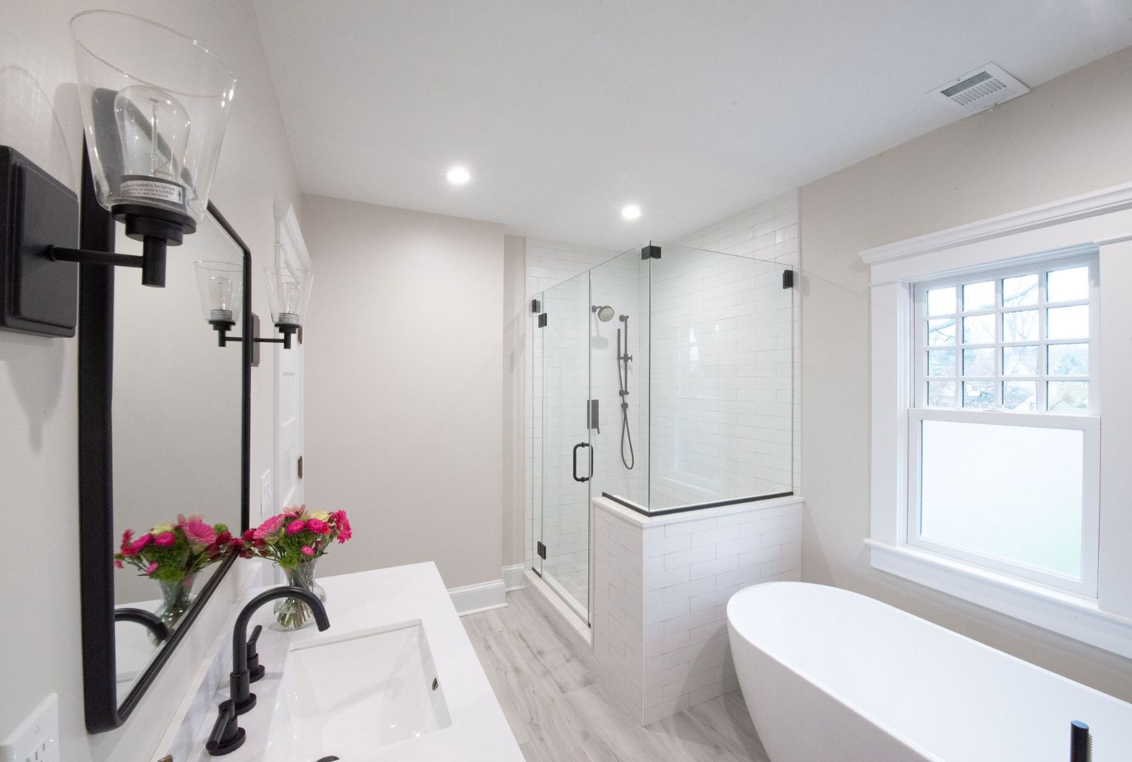 Front view of a sleek Caldwell, NJ. custom home bathroom with large walk-in shower and modern fixtures by G&L and Sons Renovations