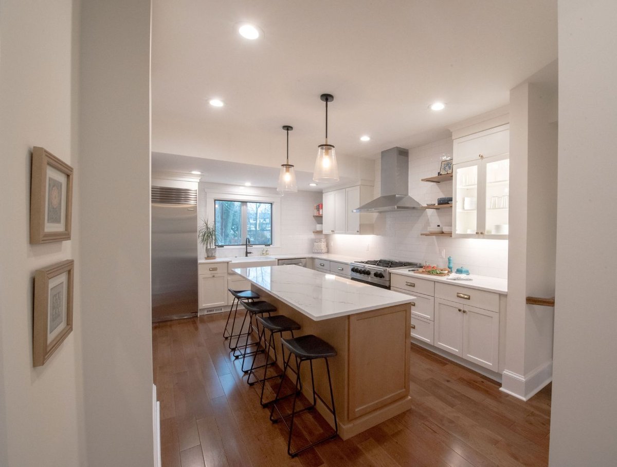 Spacious kitchen renovation with marble island and shaker cabinets by G&L and Sons Renovations in Maplewood, NJ