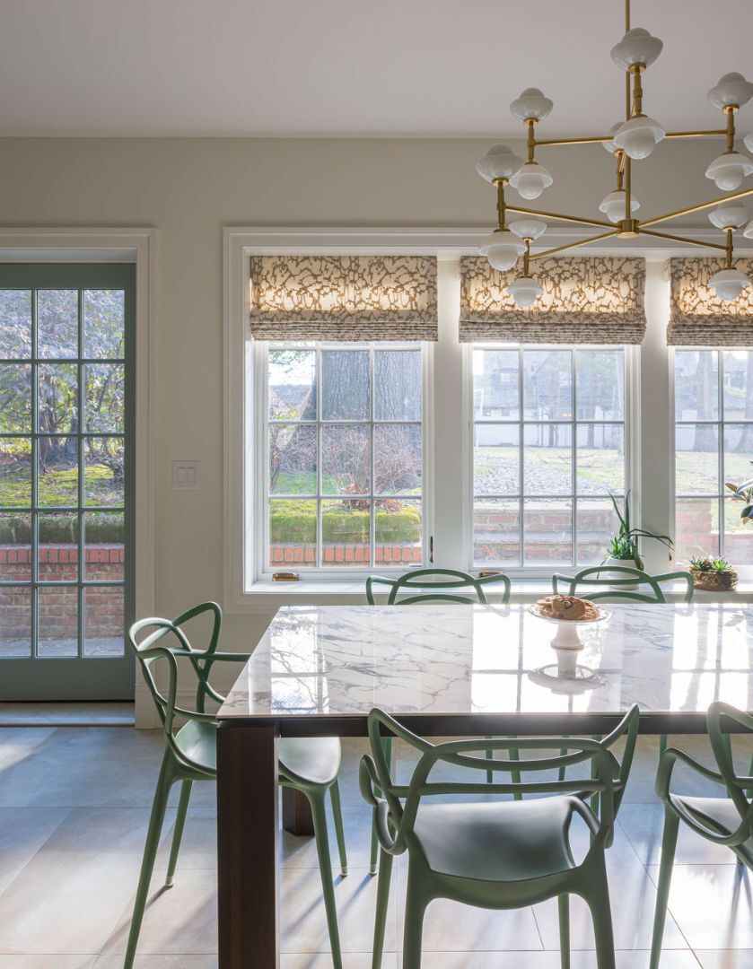 Sunlit dining area featuring statement light fixture in a South Orange, NJ custom home by G&L and Sons Renovations