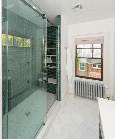 Walk-in glass shower with deep green tile and natural light in Chatham Boro, NJ by G&L and Sons Renovations