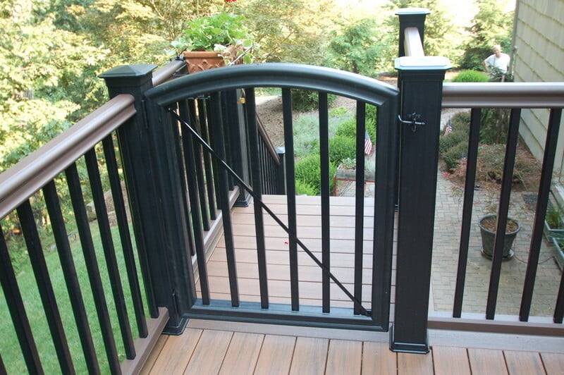 Black metal deck gate on elevated wood deck by G&L and Sons Renovations in Caldwell, NJ