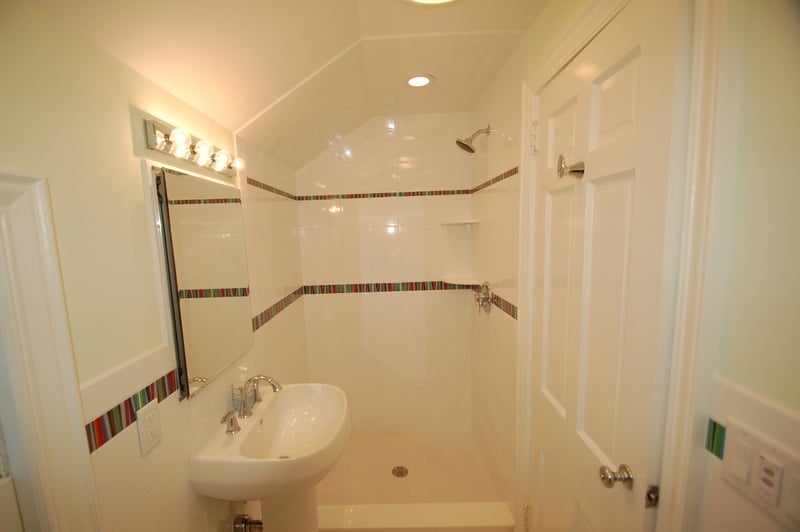 Compact custom bathroom featuring tiled shower and pedestal sink by G&L and Sons Renovations, Caldwell, NJ