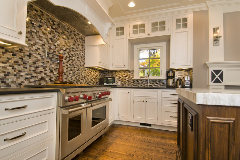 Corner view of custom kitchen with range and mosaic backsplash by G&L and Sons Renovations in Caldwell, NJ