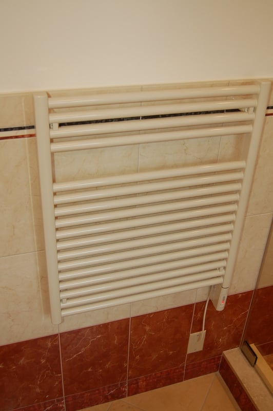 Electric towel warmer installation in a hall bathroom by G&L and Sons Renovations in Montclair, NJ