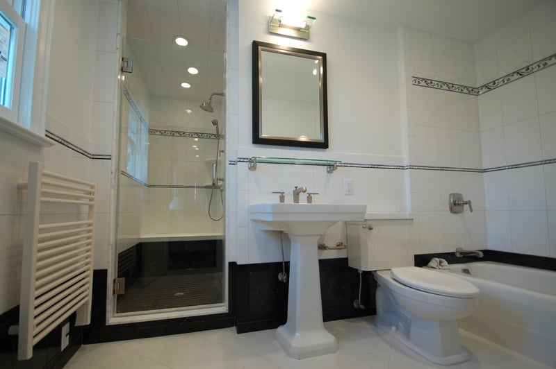 Elegant black and white tile bathroom remodel with pedestal sink by G&L and Sons Renovations in Wayne, NJ