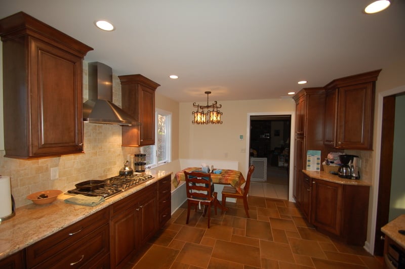 Full custom kitchen with breakfast nook and dark wood cabinets by G&L and Sons Renovations in Caldwell, NJ