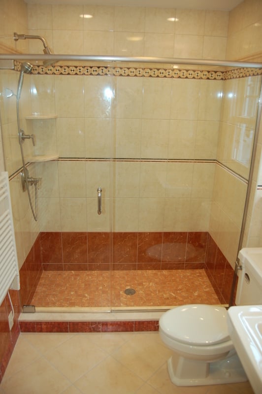 Full glass-enclosed shower remodel with accent tile band by G&L and Sons Renovations in Caldwell, NJ