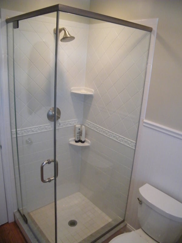 Glass-enclosed corner shower with white tile in a Glen Ridge, NJ bathroom remodel by G&L and Sons Renovations
