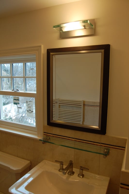 Hall bathroom remodel with framed vanity mirror and natural light by G&L and Sons Renovations in Verona, NJ