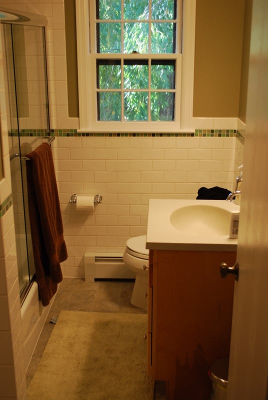 Hall bathroom remodel with white subway tile and wood vanity in a Florham Park, NJ home by G&L and Sons Renovations