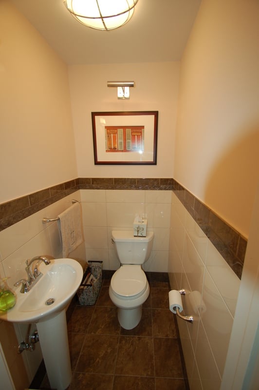 Hall bathroom renovation with framed artwork and neutral tile by G&L and Sons Renovations, Caldwell, NJ