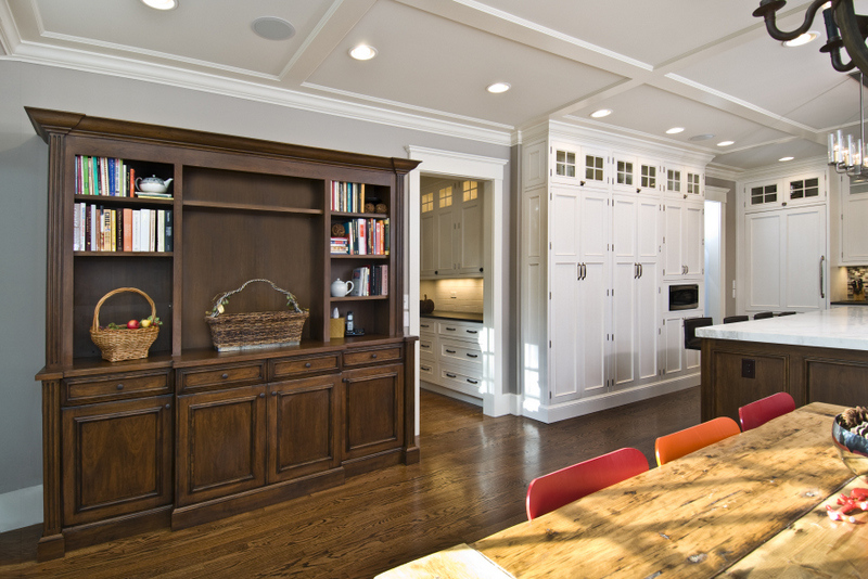 Kitchen dining space with wood bookcase and white cabinetry by G&L and Sons Renovations, Caldwell, NJ