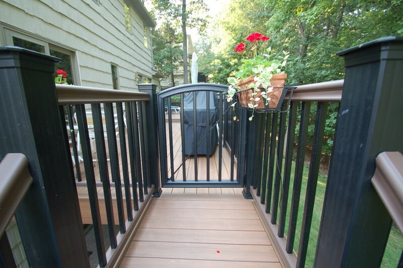 Outdoor deck gate with black railings and potted flowers by G&L and Sons Renovations, Caldwell, NJ