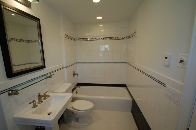 Spacious master bathroom remodel with glass shower and pedestal sink by G&L and Sons Renovations in Short Hills, NJ