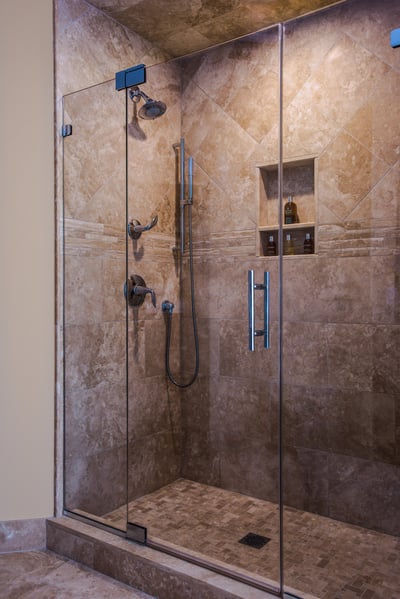 Spacious walk-in shower with glass doors and built-in niches by G&L and Sons Renovations in Caldwell, NJ