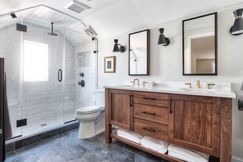 A remodeled bathroom in a New Jersey home his-and-her sinks and a walk-in shower.