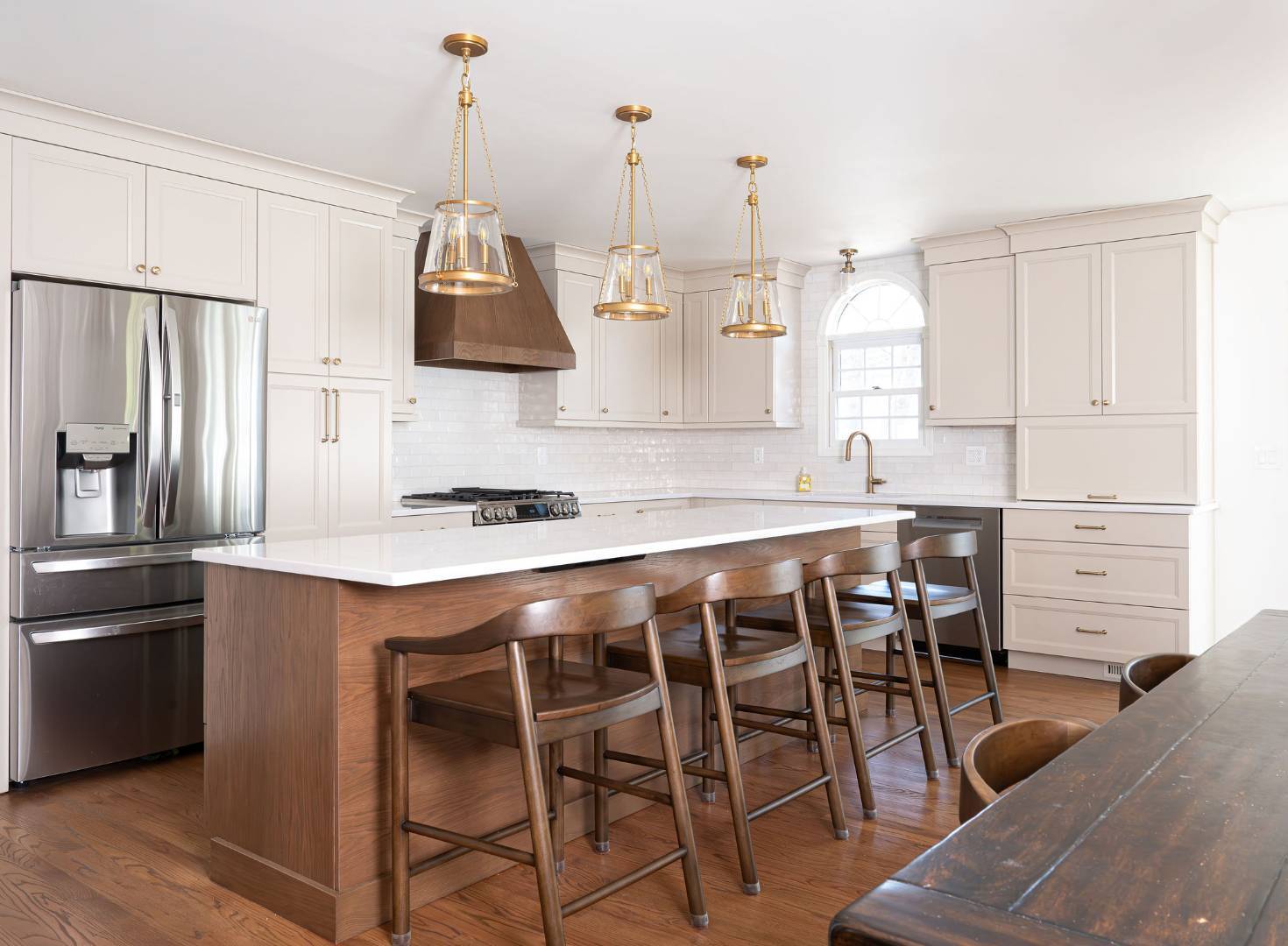 Large kitchen island and stainless steel fridge in Maplewood, NJ custom home by G&L and Sons Renovations