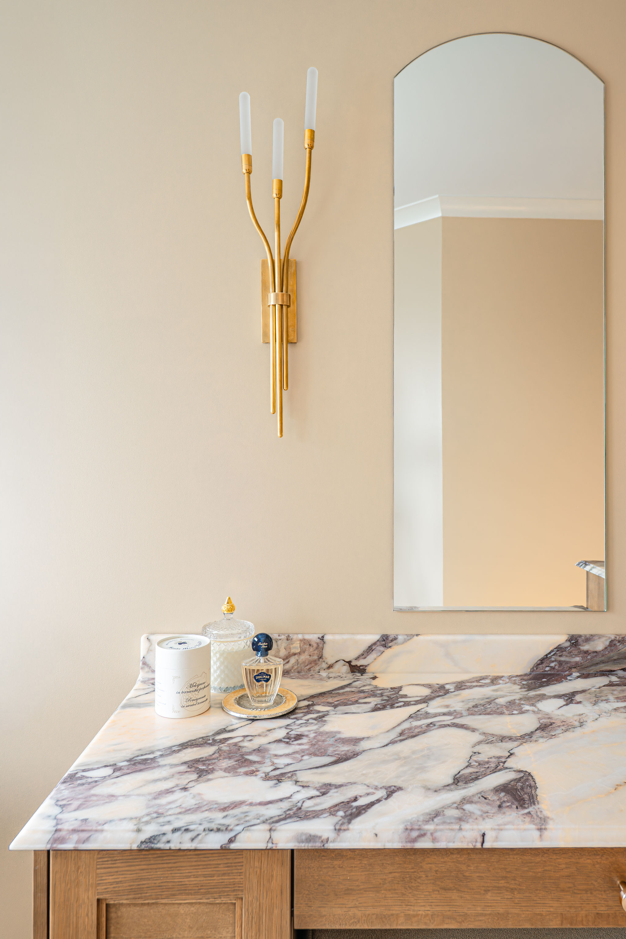 Image of a custom bathroom in Bergen County, New Jersey, with a marble counter and brass fixtures.